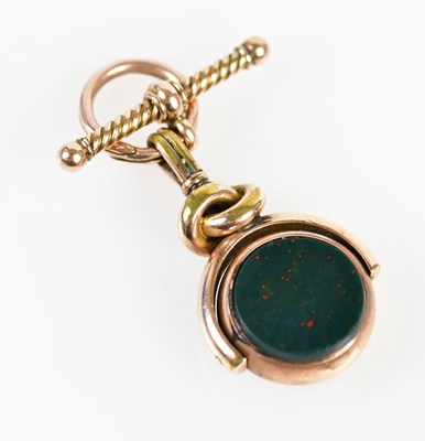 Lot 14 - A yellow metal bloodstone swivel fob set with...
