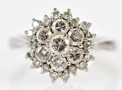 Lot 121 - An 18ct white gold and diamond domed cluster...