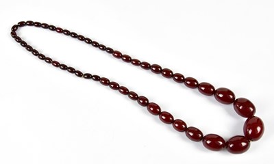 Lot 421 - A vintage cherry amber coloured graduated bead...