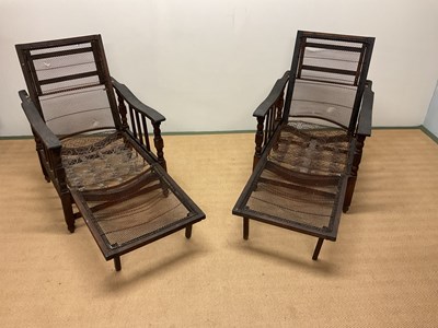 Lot 579 - A pair of oak framed planter chairs.