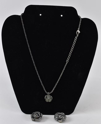 Lot 911 - CHRISTIAN DIOR; a white metal necklace...