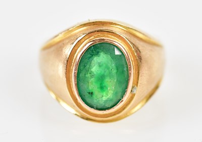 Lot 118 - A yellow metal and emerald gentleman’s ring...