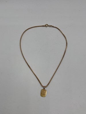 Lot 427 - A 9ct yellow gold box link chain supporting a...