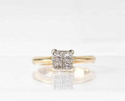 Lot 1021 - A 9ct yellow gold four-stone diamond ring,...