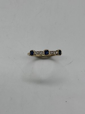 Lot 415 - A yellow metal sapphire and diamond dress ring...