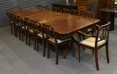 Lot 19 - A large reproduction three pedestal dining...