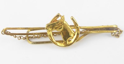 Lot 1130 - A bespoke gold tie pin with horse head within...