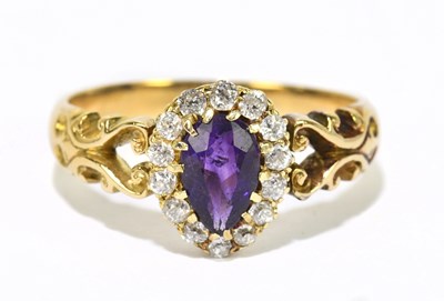 Lot 1067 - A yellow metal ring with amethyst and diamond...