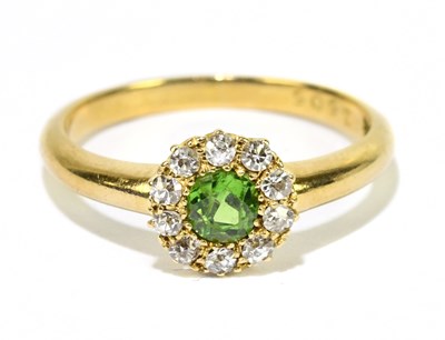 Lot 1038 - An 18ct yellow gold diamond and peridot floral...