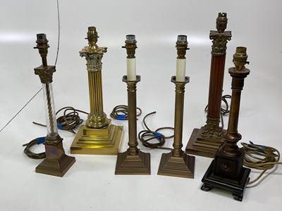 Lot 524 - Six brass column lamp bases, tallest 39cm.