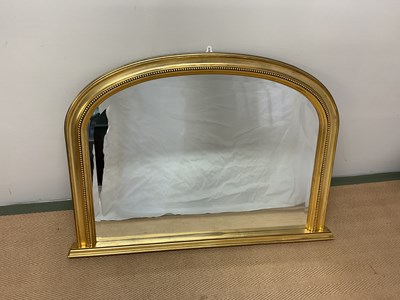 Lot 595 - A gilt framed overmantel bevelled mirror with...