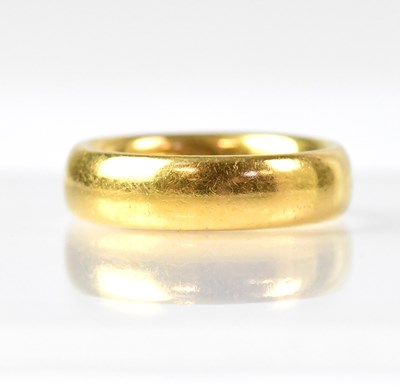 Lot 1036 - A 22ct gold wedding band, size P1/2, approx....