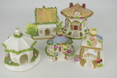 Lot 500 - COALPORT; five fine bone china cottages in the...