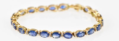 Lot 511 - An 18ct yellow gold sapphire and diamond line...