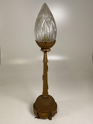 Lot 518 - An early 20th century gilded over brass lamp...