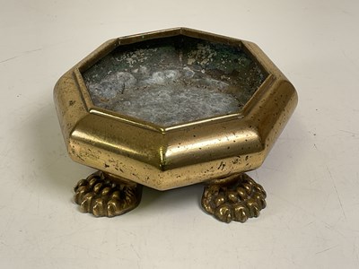 Lot 140 - An octagonal brass plant pot stand raised on...