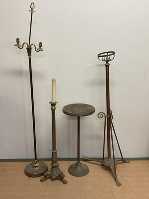 Lot 521 - Three brass floor lamps of various forms and a...