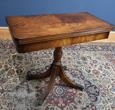 Lot 119 - A reproduction mahogany fold-over swivel top...