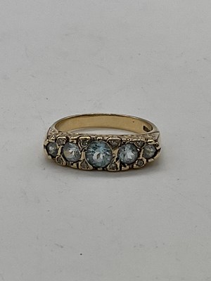 Lot 402 - A 9ct yellow gold aquamarine and diamond ring...