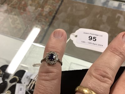 Lot 95 - An 18ct white gold sapphire and diamond oval...