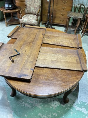 Lot 625 - An Edwardian oak extending dining table with...