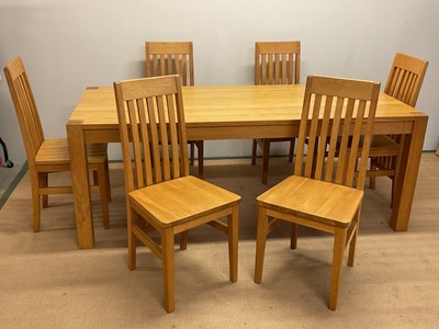 Lot 581 - A contemporary light oak dining table and six...