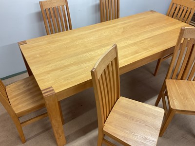 Lot 581 - A contemporary light oak dining table and six...