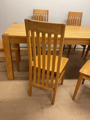 Lot 581 - A contemporary light oak dining table and six...