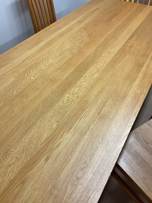 Lot 581 - A contemporary light oak dining table and six...