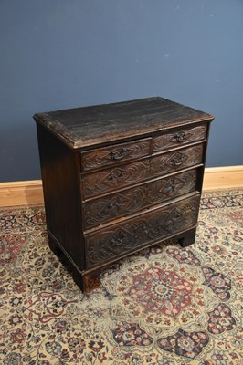 Lot 167 - A Georgian carved oak chest of two short over...