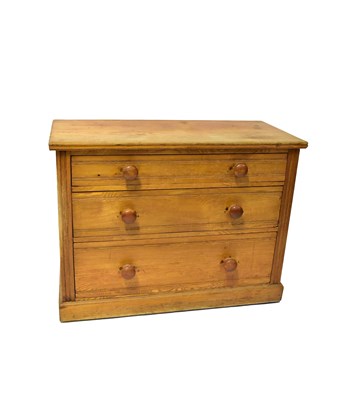 Lot 36 - An early 20th century ash three-drawer chest...