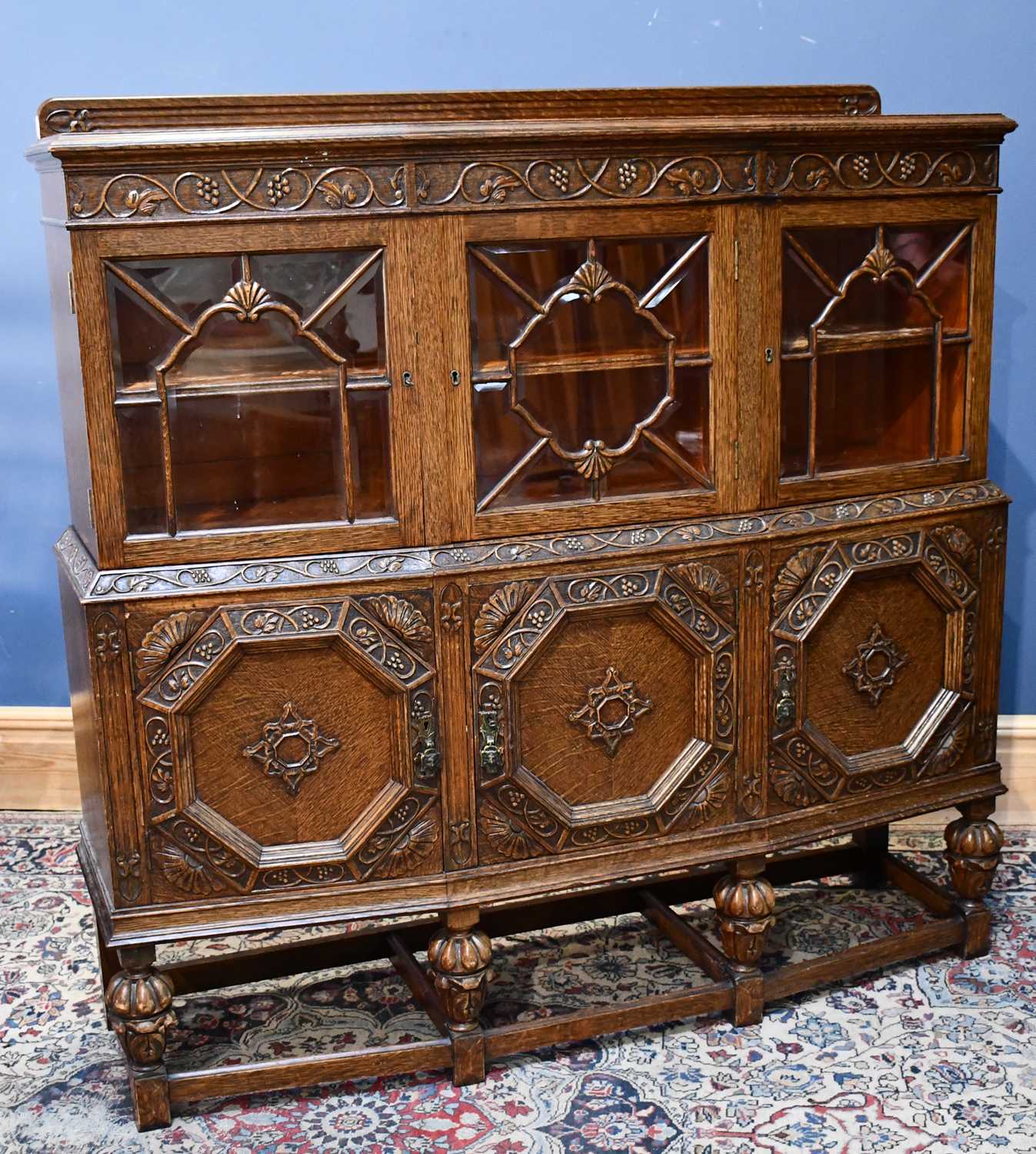 Lot 2 - A 1920s carved oak sideboard with three glazed...