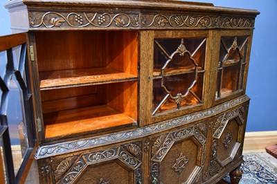 Lot 2 - A 1920s carved oak sideboard with three glazed...