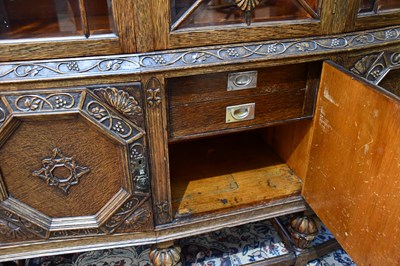 Lot 2 - A 1920s carved oak sideboard with three glazed...
