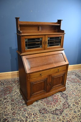 Lot 271 - An Arts and Crafts oak bureau bookcase, with...