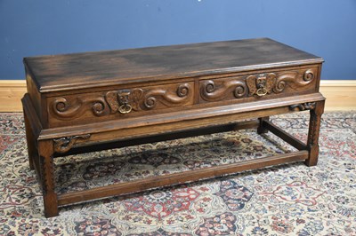 Lot 197 - A reproduction carved oak two drawer hall...