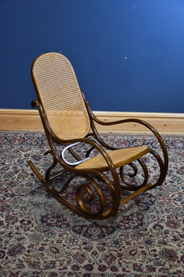 Lot 220 - A bent wood cane seated and backed rocking chair.