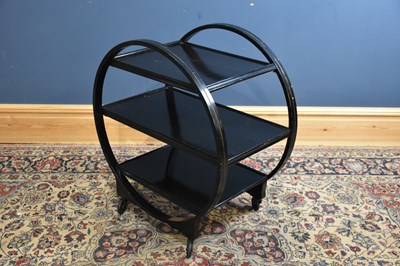 Lot 317 - A black painted Art Deco three tier cocktail...