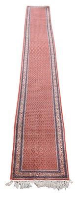 Lot 342 - A hand woven wool runner, worked with an...