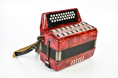 Lot 1111 - A thirty-one key red pearlescent melodeon, cased.