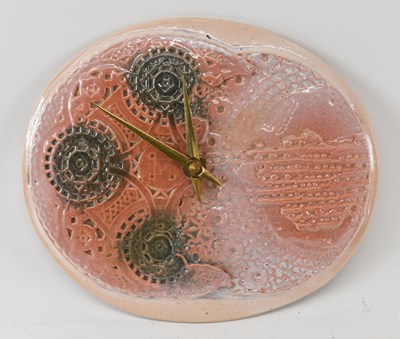 Lot 530 - A Studio Pottery oval wall clock, indistinctly...