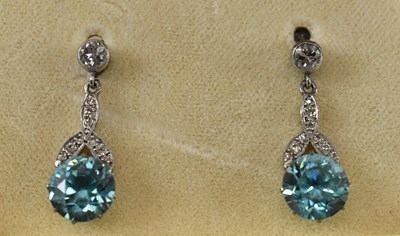 Lot 888 - A pair of white metal diamond and zircon drop...