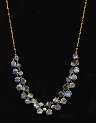 Lot 910 - A yellow metal moonstone set necklace.