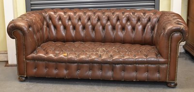 Lot 15 - A brown button upholstered leather...
