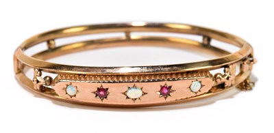 Lot 1257 - An Edwardian 9ct rose gold opal and garnet...