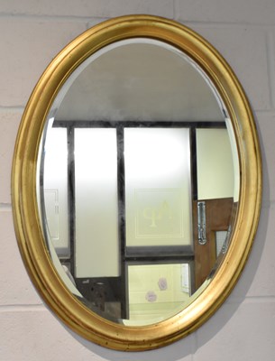 Lot 91 - A 20th century gilt framed oval wall mirror,...