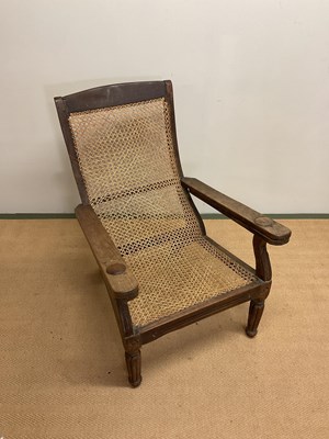 Lot 644 - A planters' chair with hinged arms and caned...