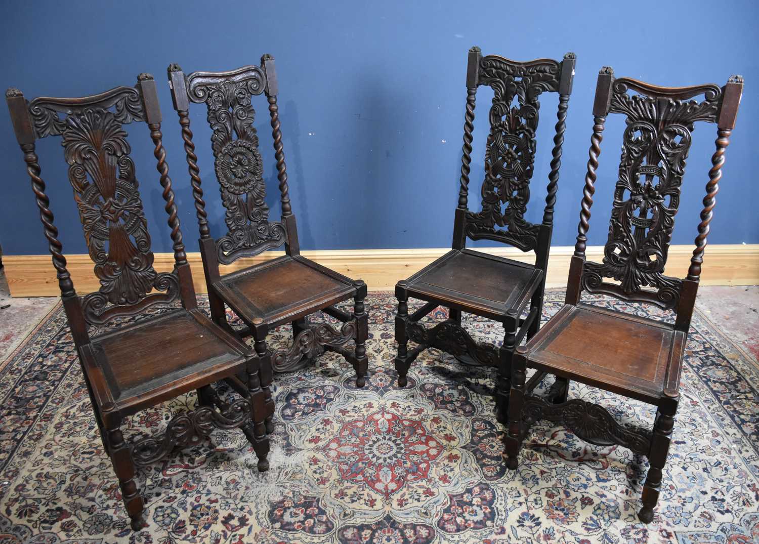 Lot 43 - Four carved oak hall chairs with panelled...