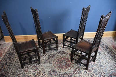 Lot 43 - Four carved oak hall chairs with panelled...