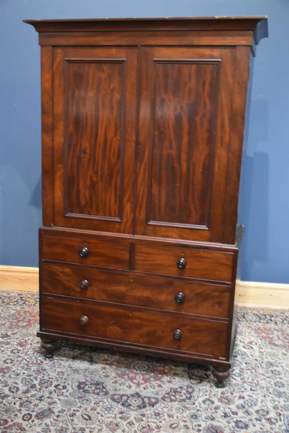 Lot 6 - A 19th century mahogany linen press, the two...